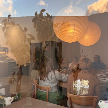 People sitting at a table with a Lanzarote reflection in the window